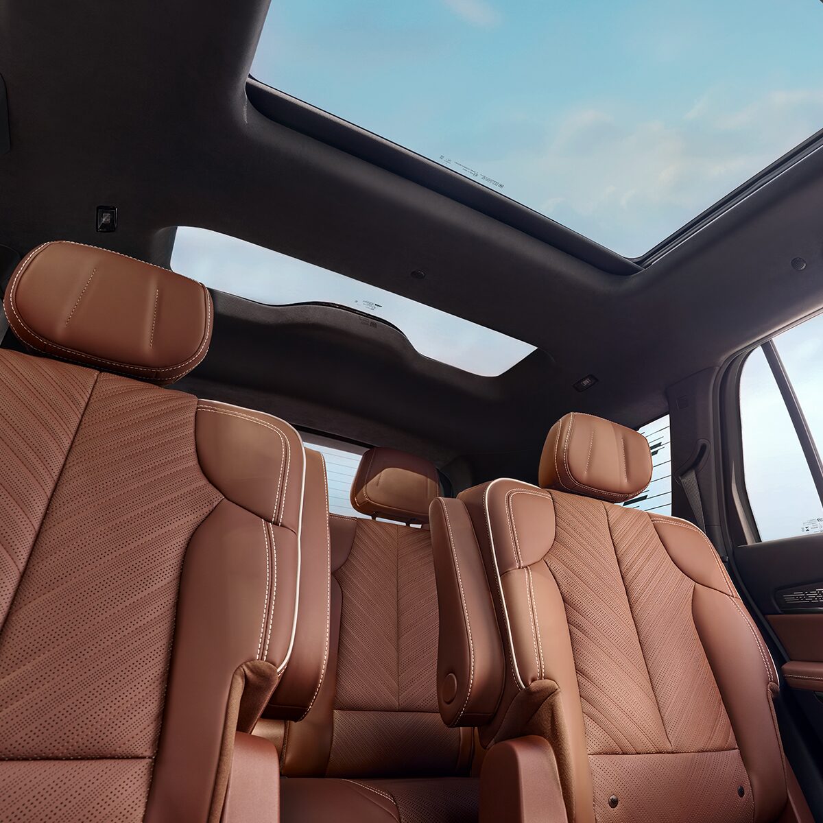 Low Interior View of the 2026 VISTIQ Second and Third Row Seating with the Sunroof Displaying a Beautiful Blue Sky