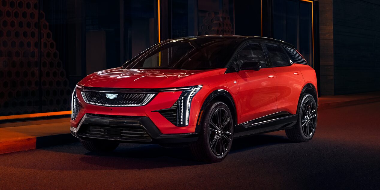 A Red 2026 Cadillac OPTIQ Parked on a Road in the Dark