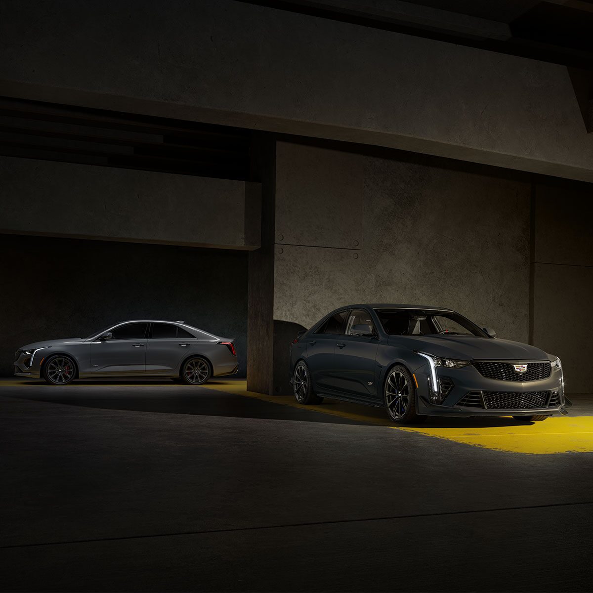 A Silver CT4-V and a Yellow CT4-V Blackwing Parked in a Parking Garage