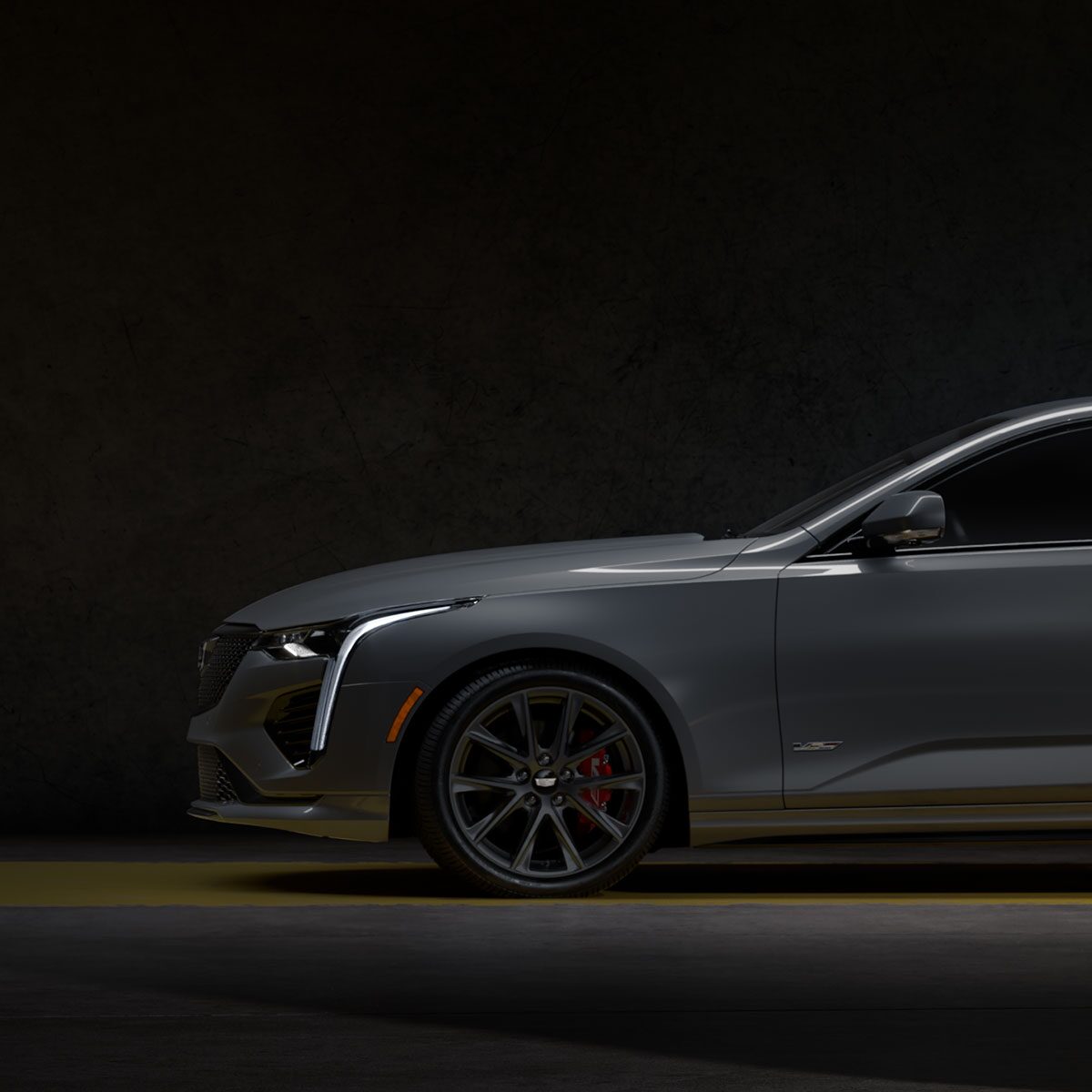 The Front Half Side Profile of a Yellow CT4-V Driving Past Mountains