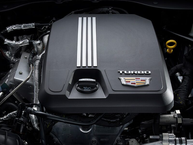 The 2026 Cadillac CT5 Steering Wheel and View of 33" Display Screen Outlooking Industrial Buildings