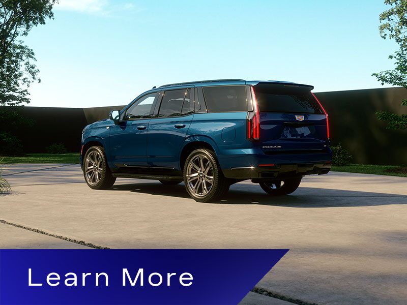 Three-Quarter Rear View of a Blue 2026 Cadillac Escalade Parked in a Driveway
