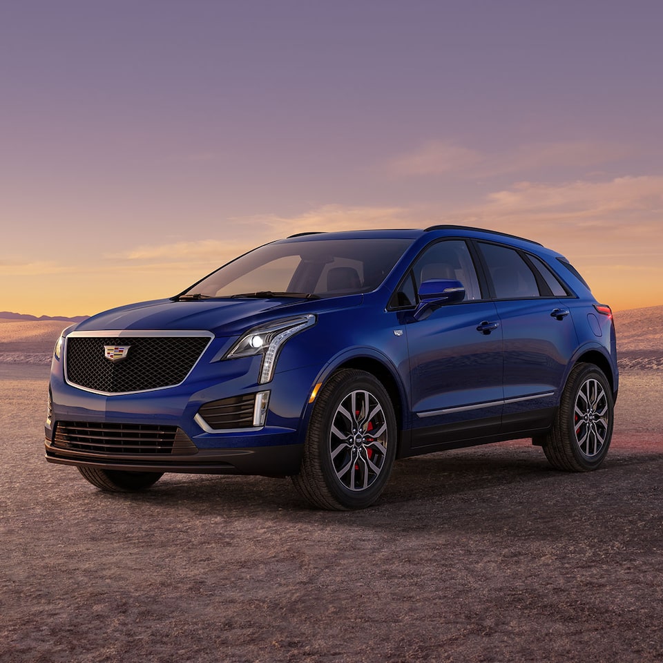 The Dark Moon Blue Metallic Cadillac XT5 Parked During the Sunset in Desert