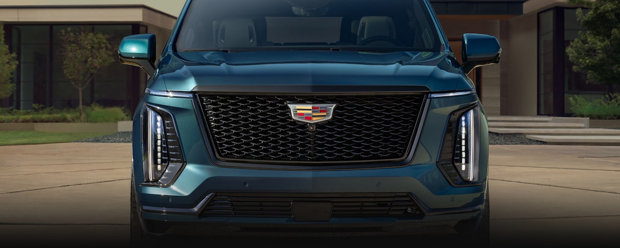Front View of a Blue 2025 Cadillac Escalade Grille Parked in Driveway