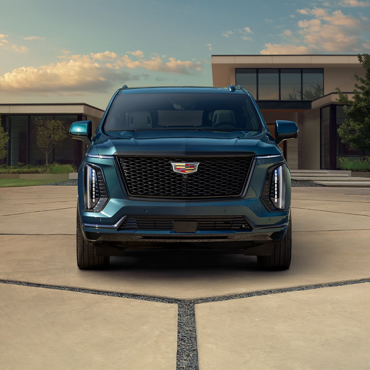 Front View of a Blue 2025 Cadillac Escalade Grille Parked in Driveway