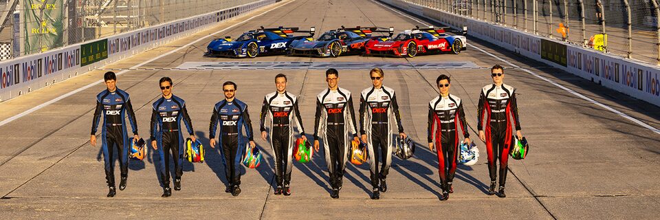 Cadillac Racing Team Members Lined Up Walking Away From Parked Race Cars on the Track