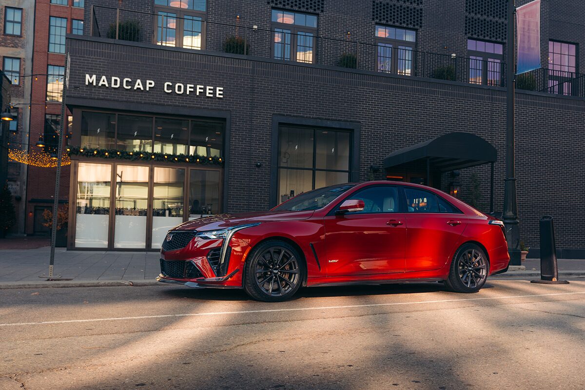 Side View of a Red Cadillac CT4-V Parked Outside of a Coffee Shop
