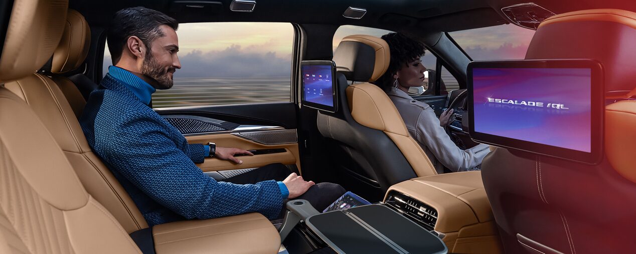 Man Smiling While Riding in the 2026 Cadillac ESCALADE IQL Executive Second Row