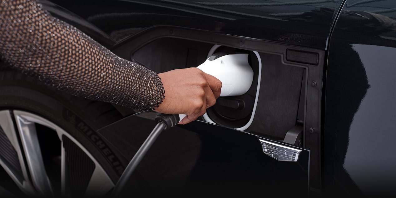 A Woman Plugs In the Charging Cord to the Charging Port on the Cadillac LYRIQ
