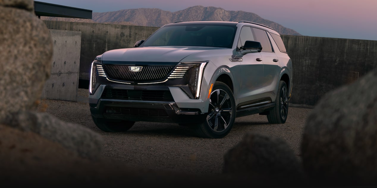 Front-side view of the 2026 Cadillac Escalade IQL parked alone in the evening.