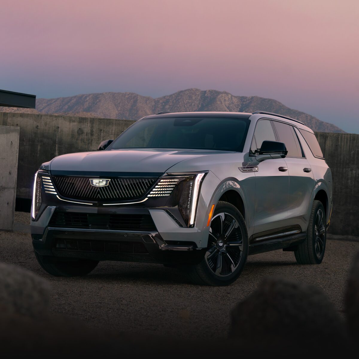 Front-side view of the 2026 Cadillac Escalade IQL parked alone in the evening.